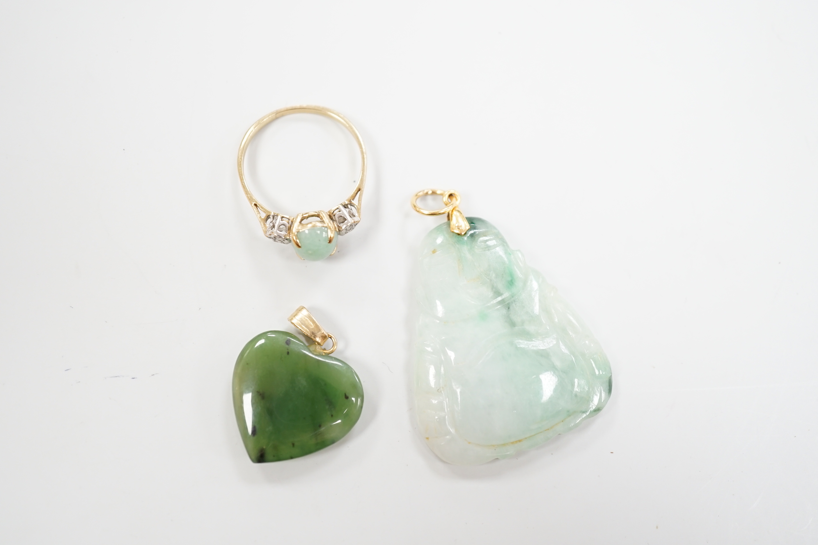 Two mounted jade pendants, including heart shaped nephrite and a 9ct gold, simulated jade and diamond chip set ring.